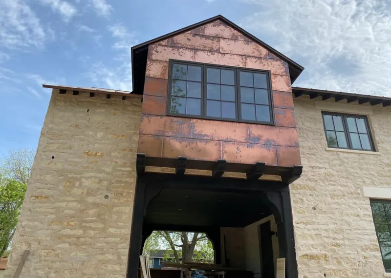 Copper metal panel facade on a stone building for Metal Roof Coating in Coral Hills