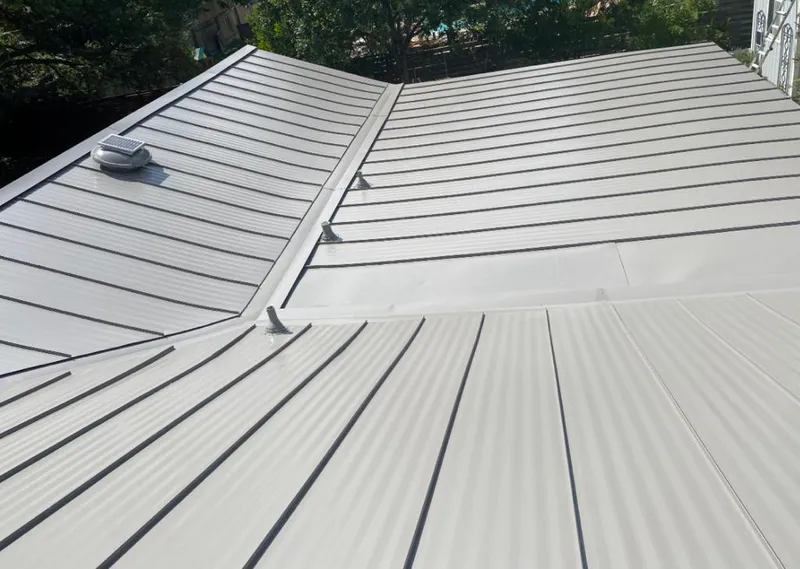 Solar attic fan installed on a metal roof for Roof Ventilation in Coral Hills